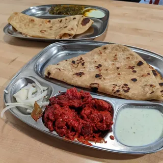 Ghareeb Nawaz signature dishes Chili Chicken Paratha, Butter Chicken, Biryani (various kinds), Samosas, various vegetarian curries.